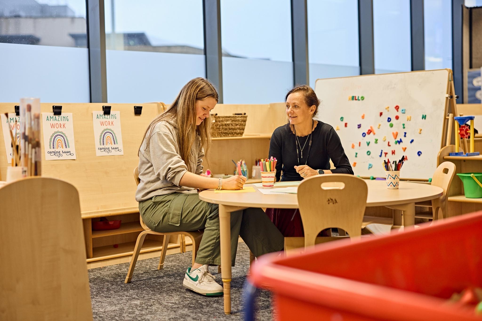 Student and teacher having a meeting in an Early Years classroom