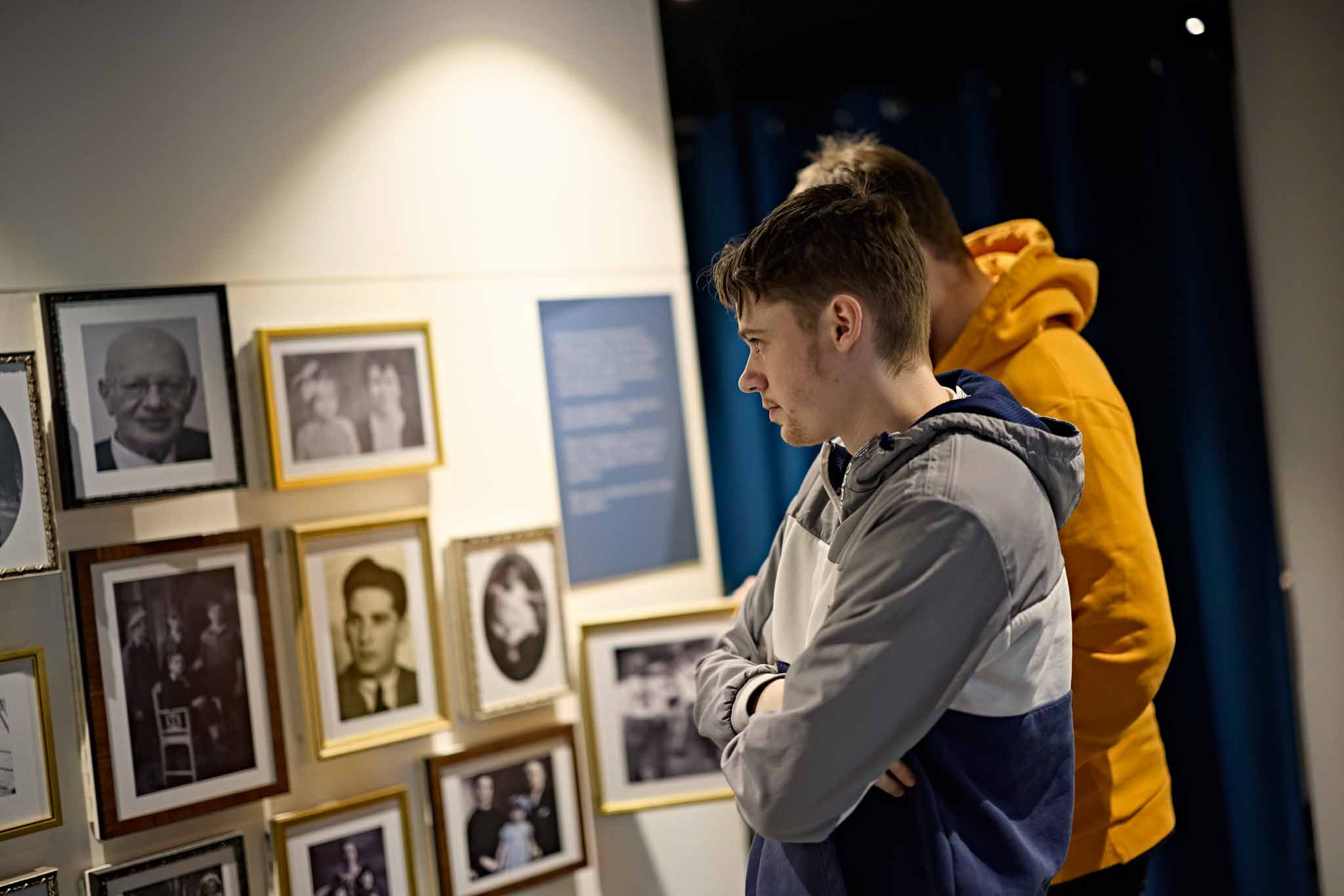 Students looking at history artifacts on a museum wall