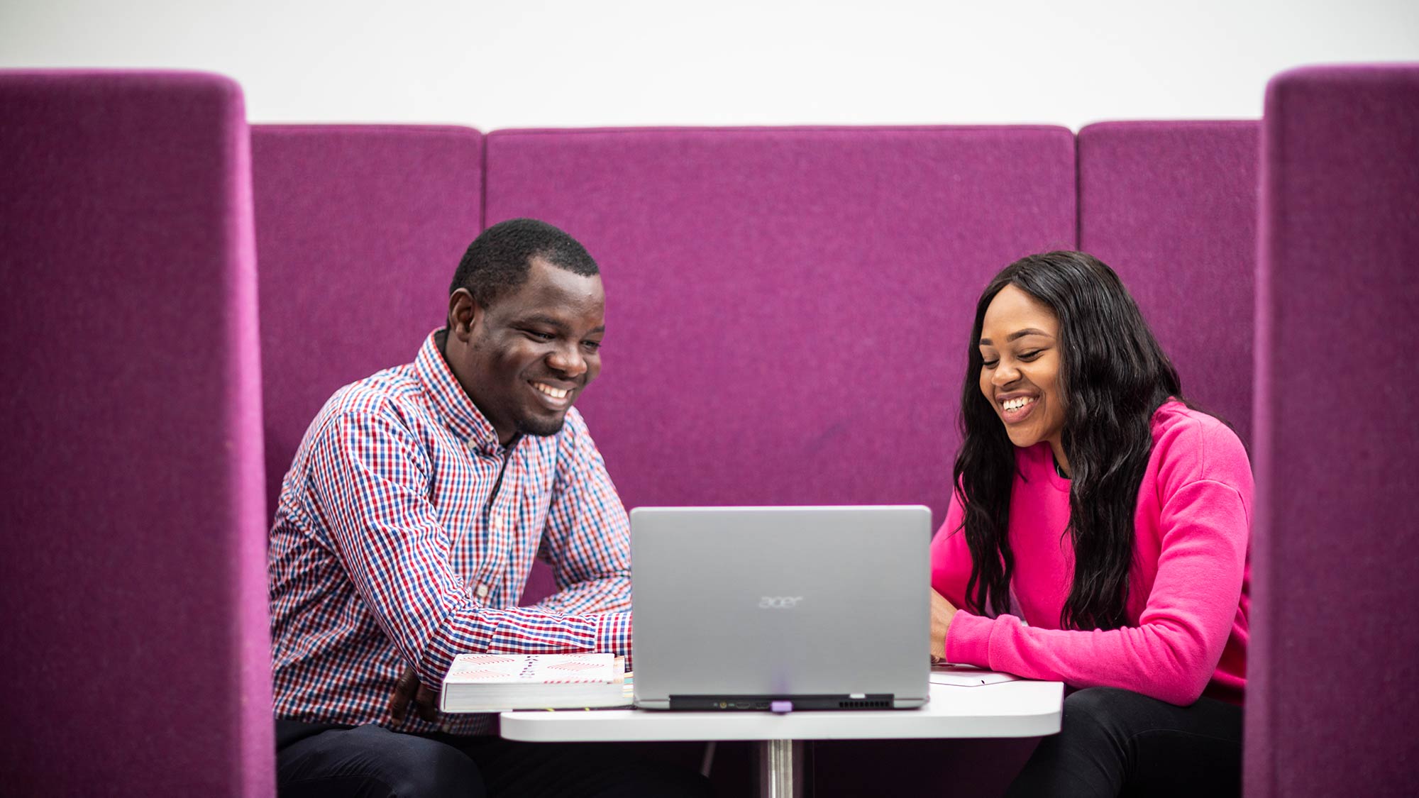 Two students look at a computer together in the Careers department