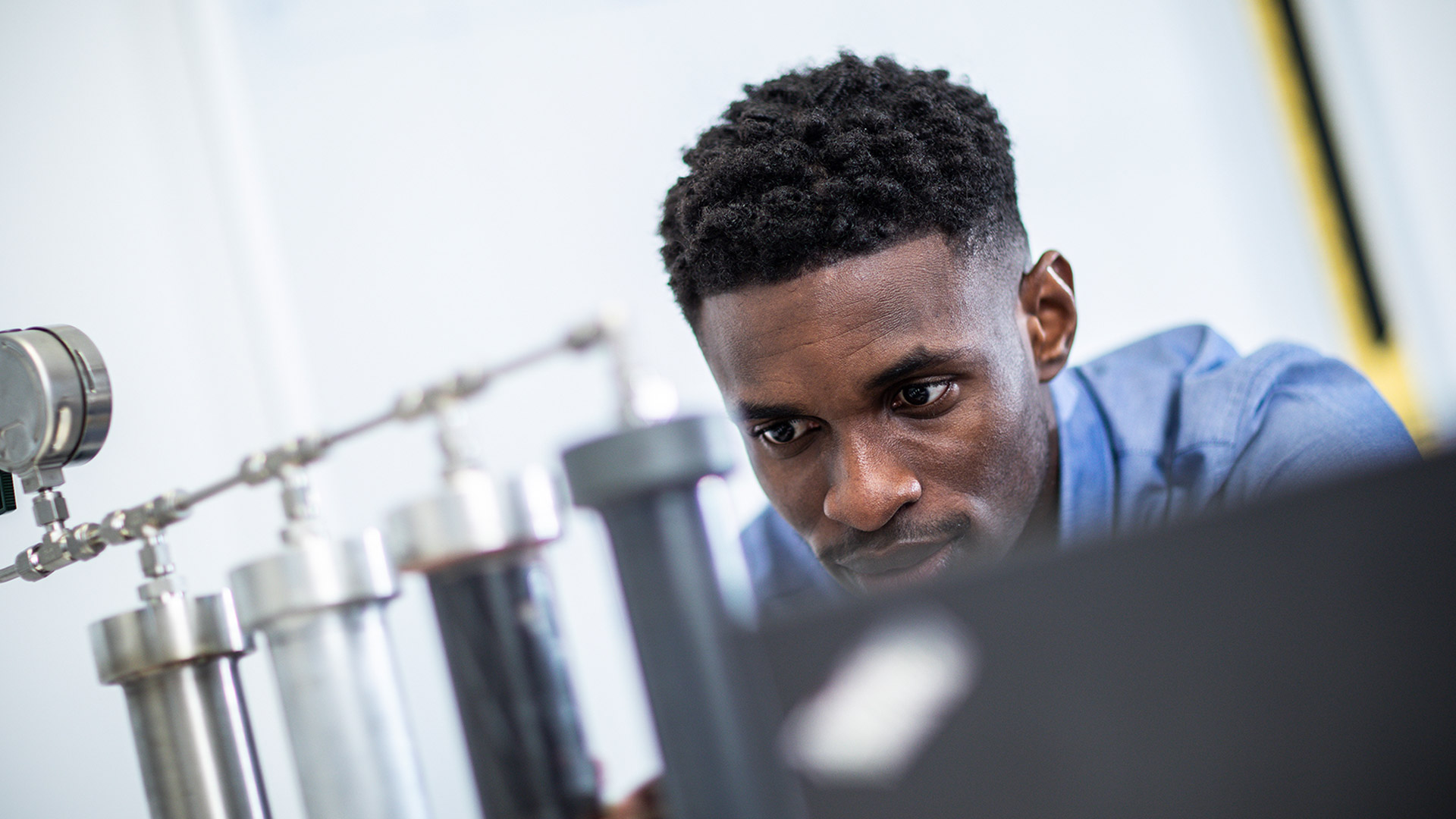 Closeup shot of a Mechanical Design Engineering MSc working with specialist equipment.