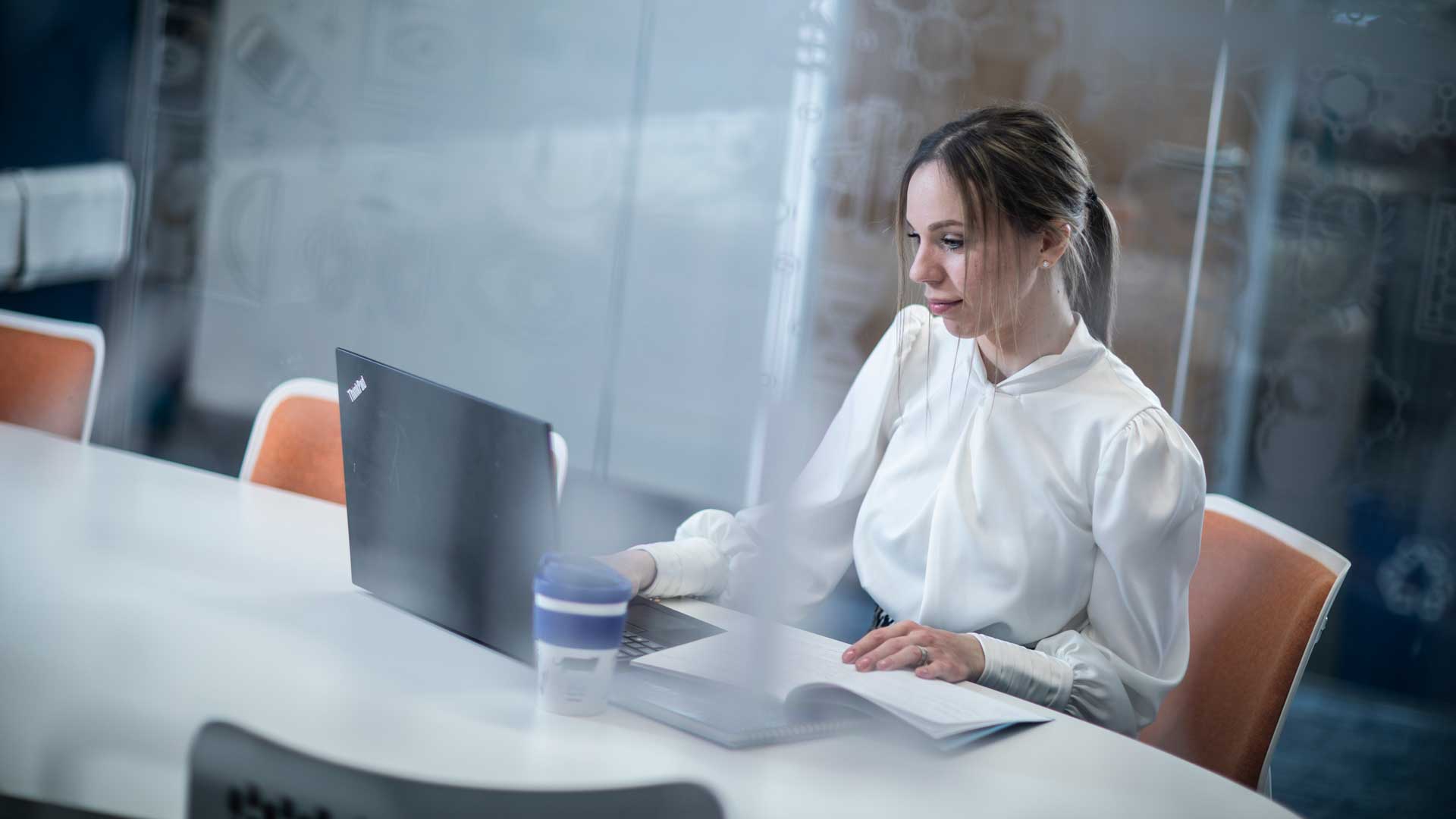 student on laptop with a coffee