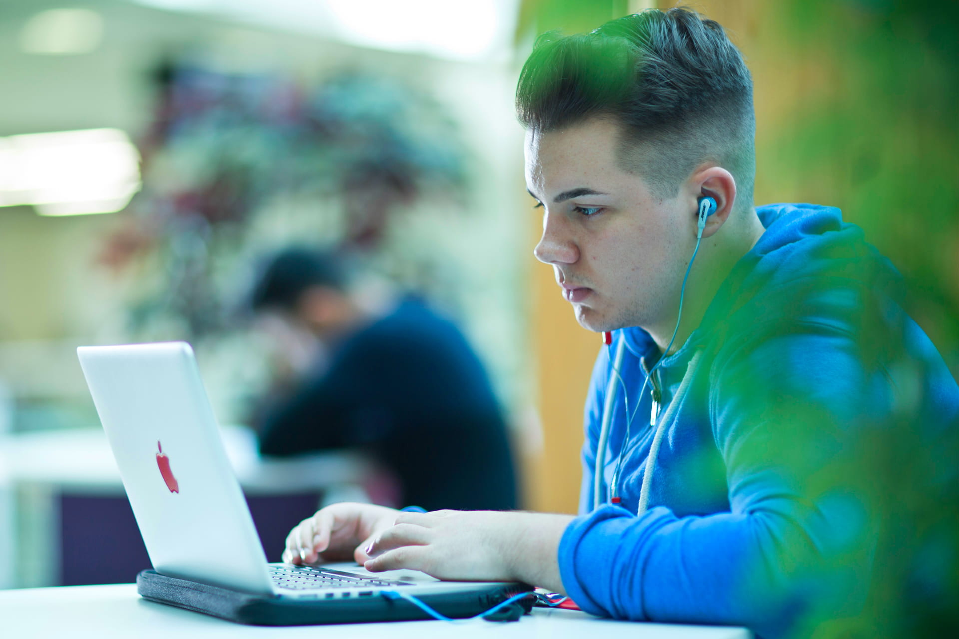 A picture of a student studying on the street, which is situated inside the business school which is open to all staff and students.